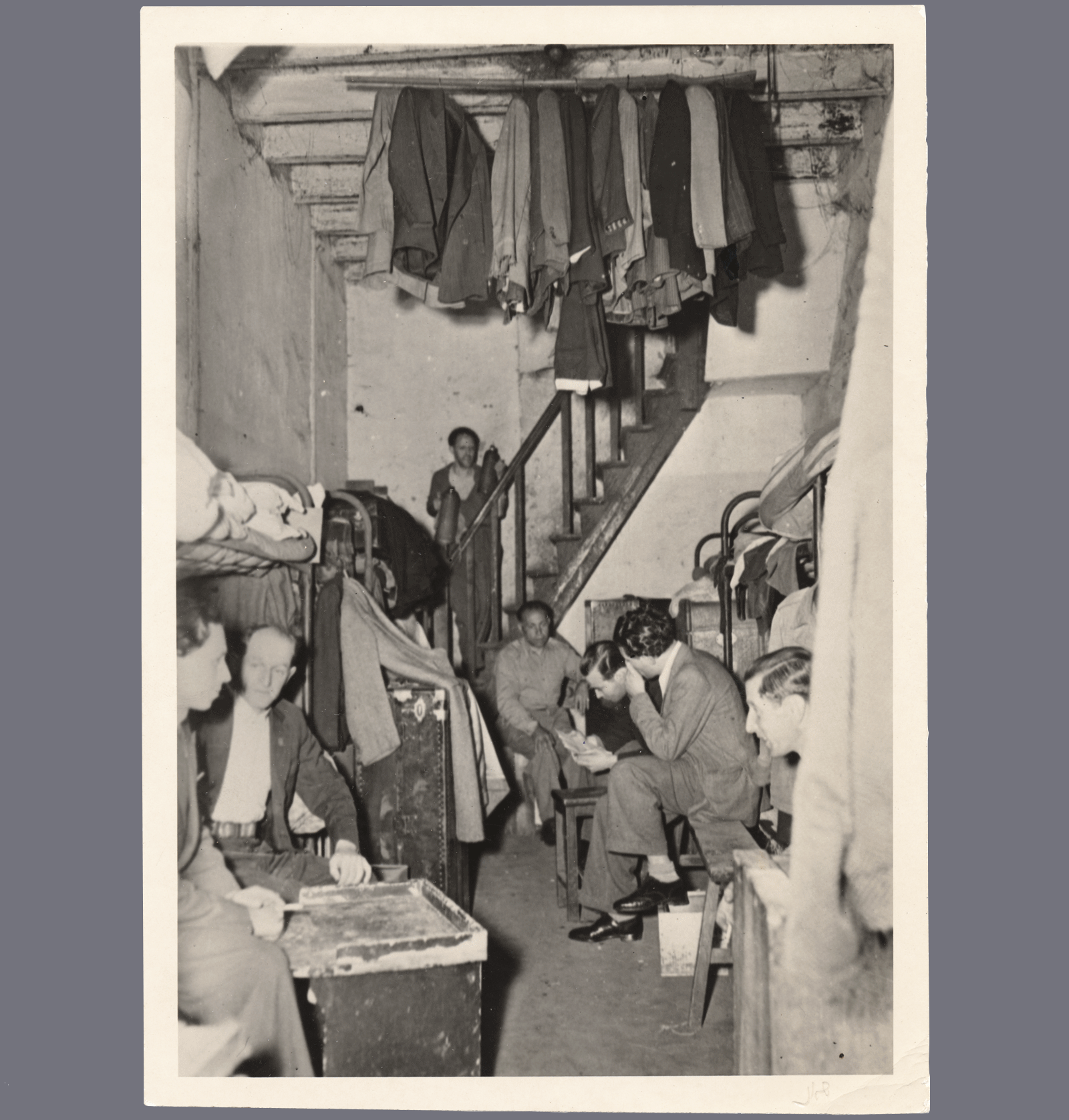 Men in a crowded dormitory in a refugee camp or in the ghetto in Shanghai