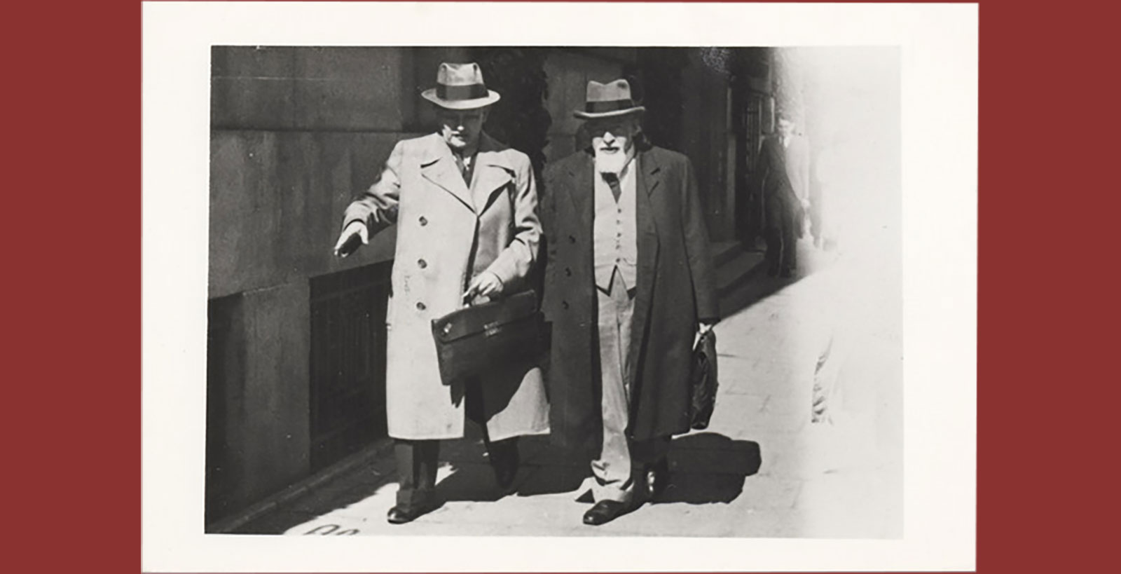 Two secular men wearing coats.