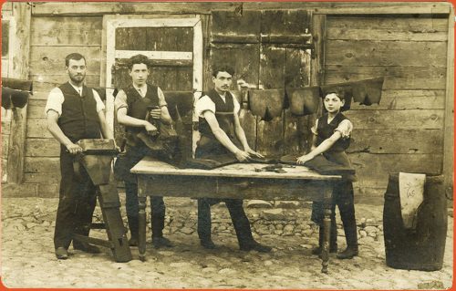 Four young leather workers outdoors