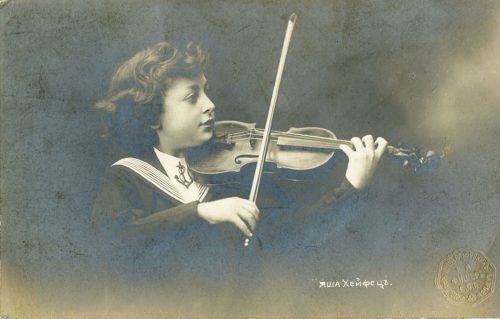 A young musician posing with violin