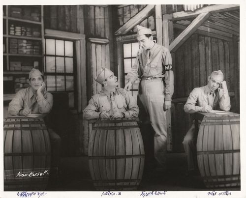 Four actors in army uniform performing a Yiddish play