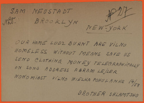 Cable to Brooklyn, New York, United States. Handwritten with black ink, block letters, on white paper. It says: "Our home Lodz burnt are Vilno homeless without means save us send clothing money telegraphically on sons address Abram Lejzer Nowomiast Vilno Wileka Pohulanka 14/58. Brother Shlamtsho"