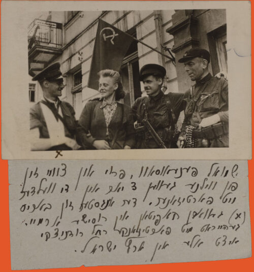 A group of 4 people stands in front of a building. The shot is a little from below looking up. We see a man, a woman, and two more men from left to right, all looking at each other. On the back is the flag of the Soviet Union.